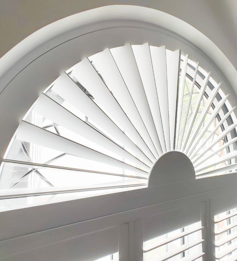 Sunburst shaped shutters in a Georgian arched window